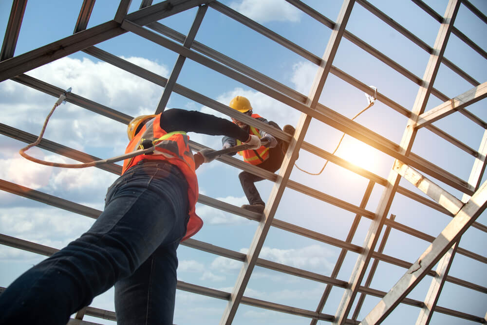 two male roofers installing roofing system